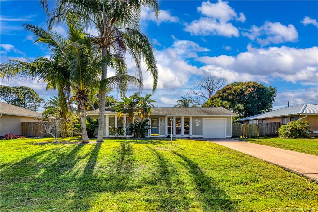 656 Southeast Ron Rico Terrace Port St. Lucie, FL 34983 - Photo 2 of 20 a view of a house with swimming pool and a small yard