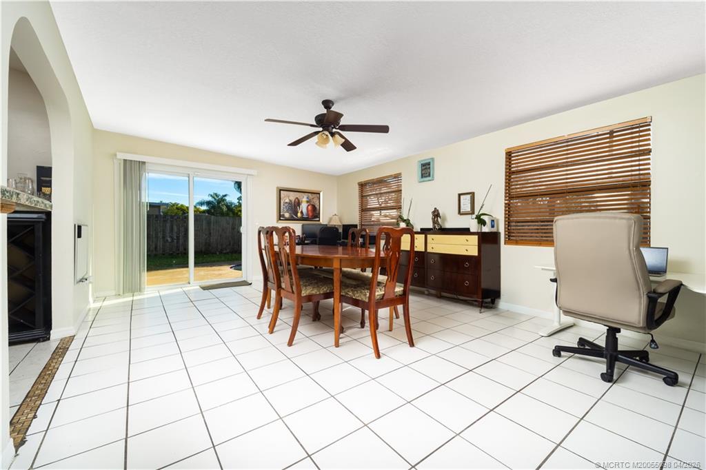 656 Southeast Ron Rico Terrace Port St. Lucie, FL 34983 - Photo 5 of 20 a view of a workspace with furniture and a window