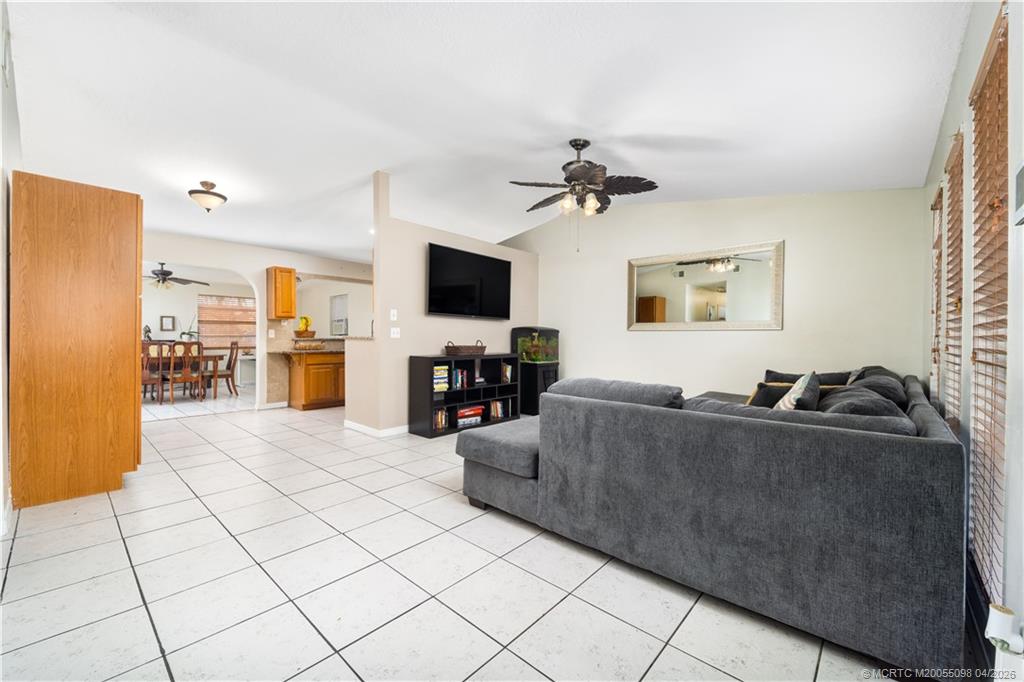 656 Southeast Ron Rico Terrace Port St. Lucie, FL 34983 - Photo 7 of 20 a living room with furniture and a flat screen tv