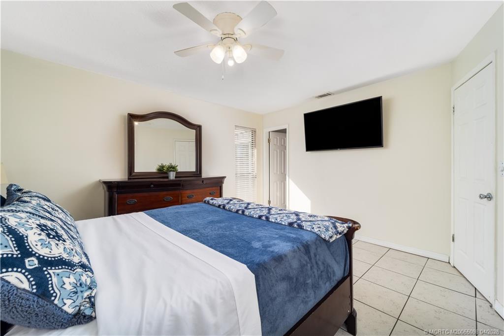 656 Southeast Ron Rico Terrace Port St. Lucie, FL 34983 - Photo 9 of 20 a bedroom with a bed and a flat screen tv