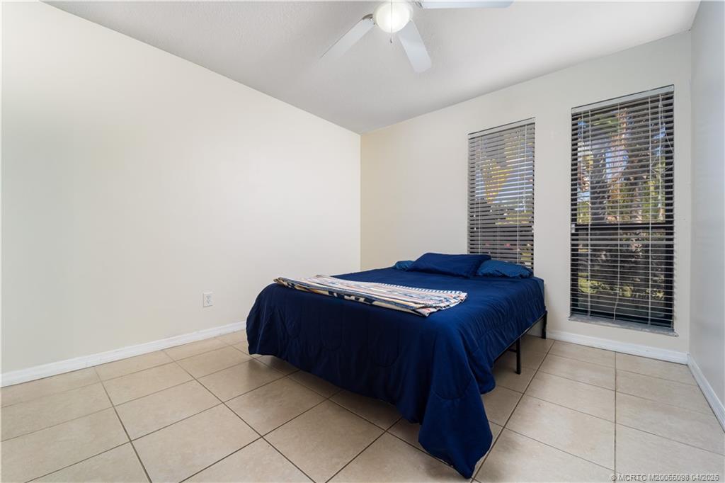 656 Southeast Ron Rico Terrace Port St. Lucie, FL 34983 - Photo 10 of 20 a bedroom with a bed and a window