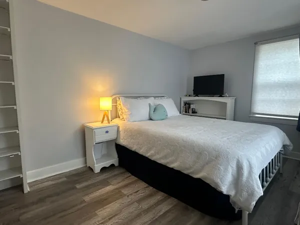 a bedroom with a bed and a television