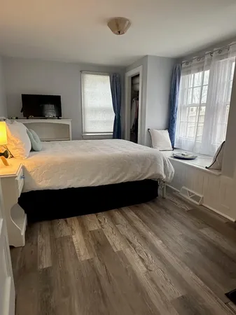 a bedroom with a bed and window