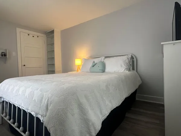 a bedroom with a bed and a lamp