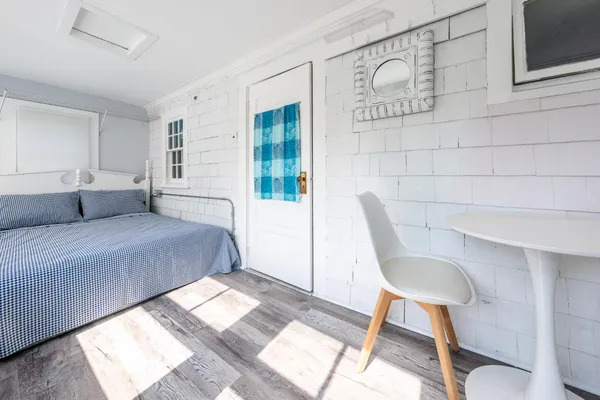 a bedroom with a bed and chair