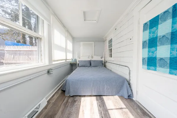 a bed room with a bed and a large window