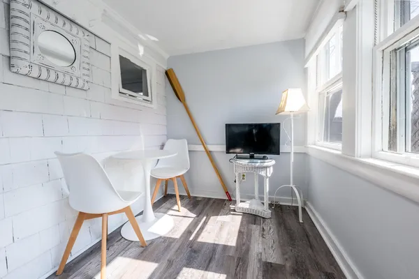 a room with a bed and windows