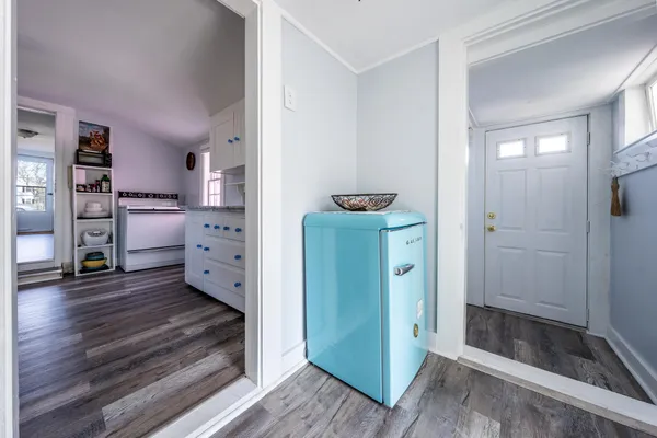a view of a hallway with wooden floor and closet