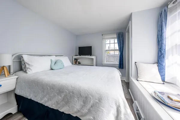 a bedroom with a bed and window