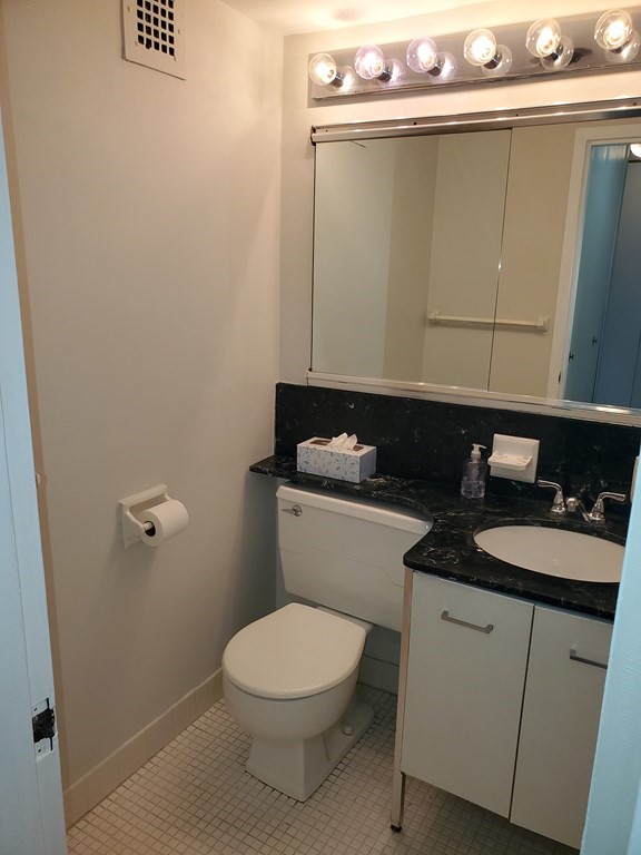 2 Hawthorne Place, Unit 7B Boston, MA 02114 - Photo 7 of 11 a bathroom with a granite countertop sink and a toilet