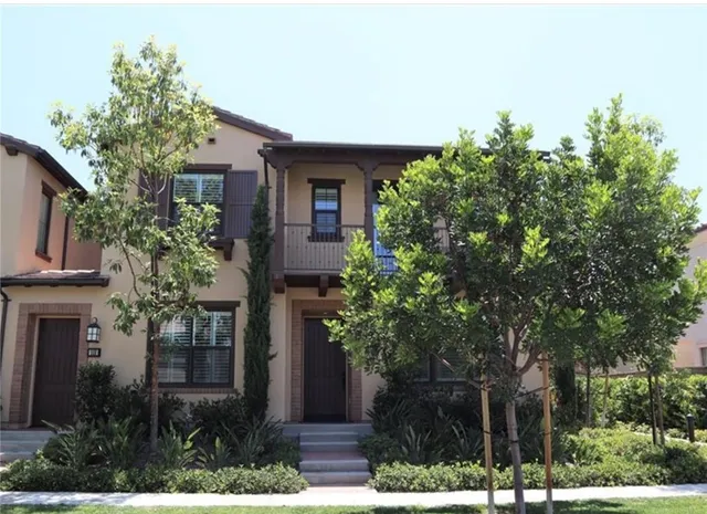 a front view of a house with trees