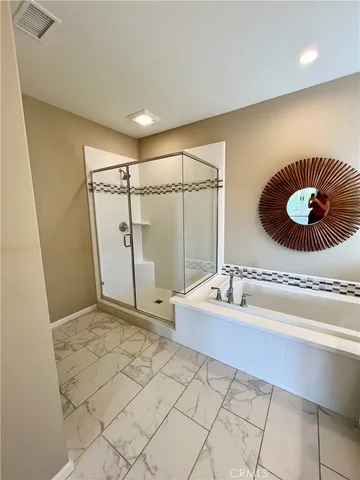 a bathroom with a sink a mirror and a shower
