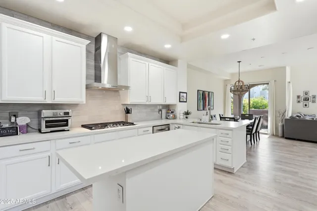 a kitchen with a sink dishwasher and white cabinets