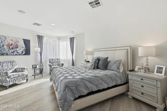 a bedroom with a bed and a night stand