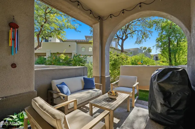 a view of balcony with furniture and a potted plant