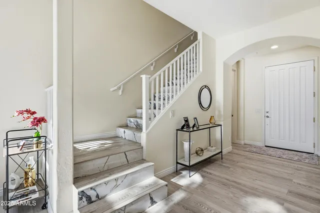 a bedroom with a bed and a painting on the wall