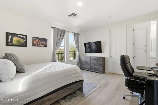 a bedroom with a bed and a chair