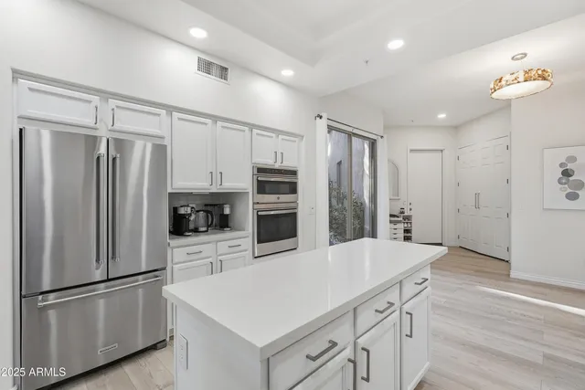 a kitchen with a white cabinets stove and refrigerator