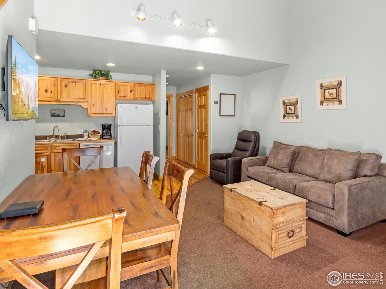 1340 Fall River Drive, Unit E Estes Park, CO 80517 - Photo 10 of 28 a living room with furniture and a table