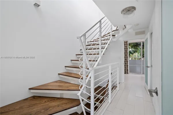 a view of entryway and hall with wooden floor