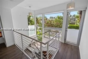 a view of a balcony with furniture and wooden floor