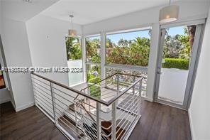 1600 Michigan Avenue, Unit 7 Miami Beach, FL 33139 - Photo 19 of 28 a view of a balcony with furniture and wooden floor