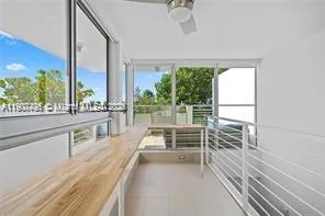 wooden floor in an empty room with a large window