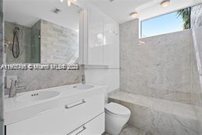 1600 Michigan Avenue, Unit 7 Miami Beach, FL 33139 - Photo 4 of 28 a bathroom with a sink a toilet and shower