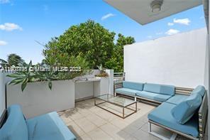 1600 Michigan Avenue, Unit 7 Miami Beach, FL 33139 - Photo 10 of 28 a view of a chairs and table in a patio