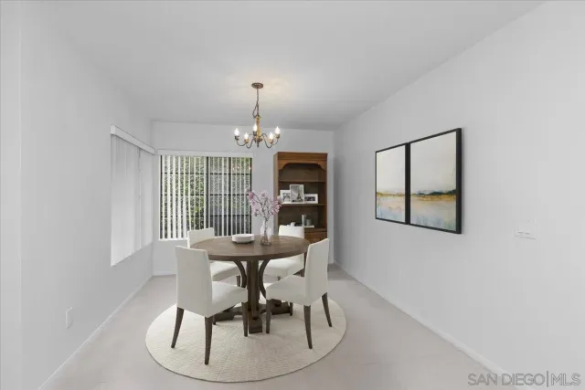a view of a dining room with furniture wooden floor and chandelier