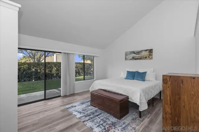a bedroom with a large bed and a wooden floor