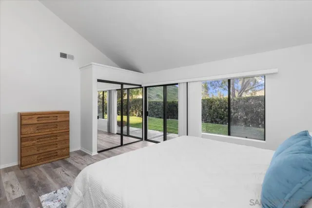 a bedroom with a bed and a large window