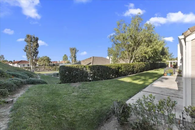 a view of a garden with a building in the background