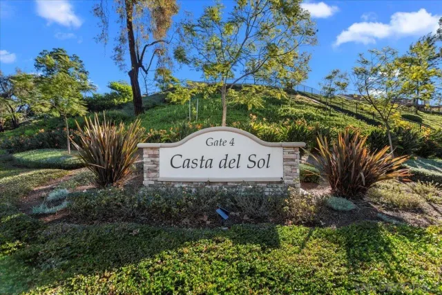 a sign broad in front of flowers