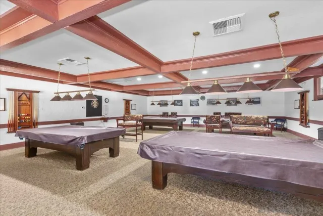 a room with stainless steel appliances kitchen island granite countertop lots of furniture