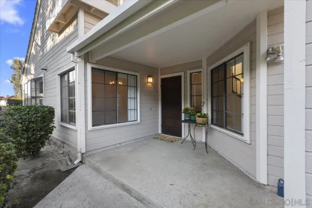 a view of a porch with a table and chairs and couches