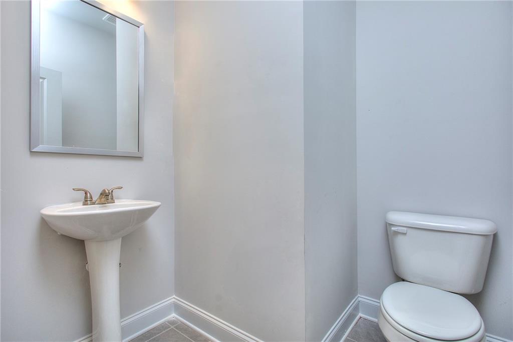 168 Chapman Ridge Road Macon, GA 31211 - Photo 17 of 32 a bathroom with a toilet sink and mirror