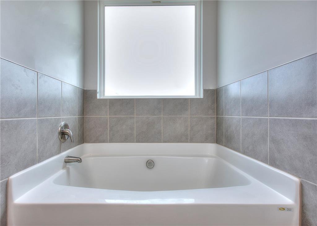 168 Chapman Ridge Road Macon, GA 31211 - Photo 23 of 32 a bathroom with a bathtub