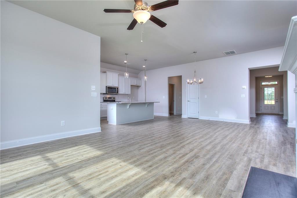 168 Chapman Ridge Road Macon, GA 31211 - Photo 6 of 32 a view of a kitchen with a dishwasher cabinets and wooden floor