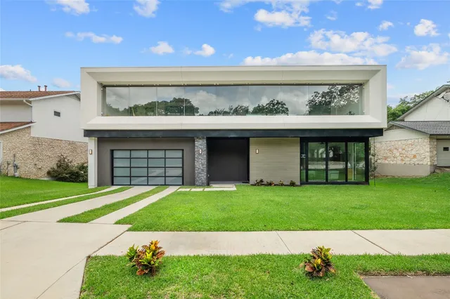 a view of a swimming pool with a yard and plants