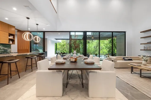 a room with furniture a large window and a view of living room