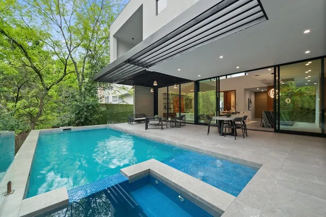 a view of a patio with table and chairs potted plants with wooden floor and fence