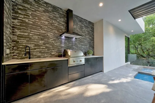 a kitchen with stainless steel appliances a sink stove and cabinets