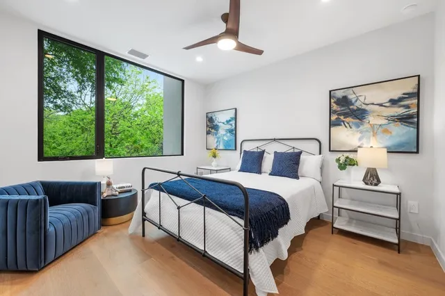 a bedroom with a large bed and a large window