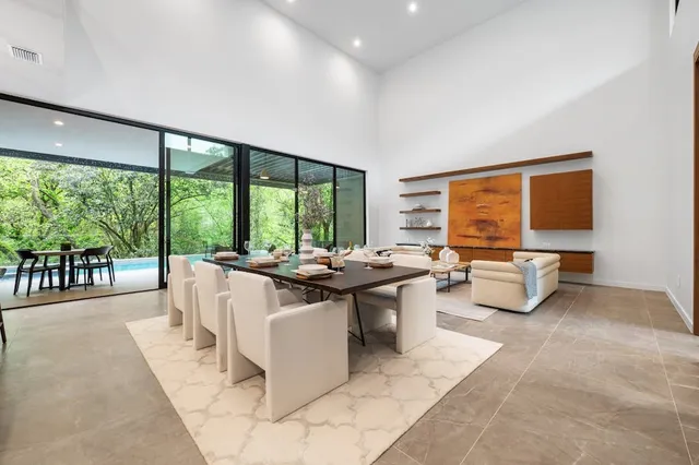a living room with couches a coffee table and a flat screen tv