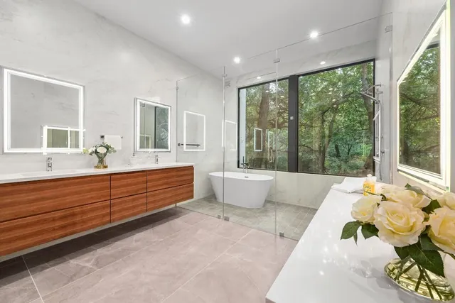 a spacious bathroom with a large tub and sink