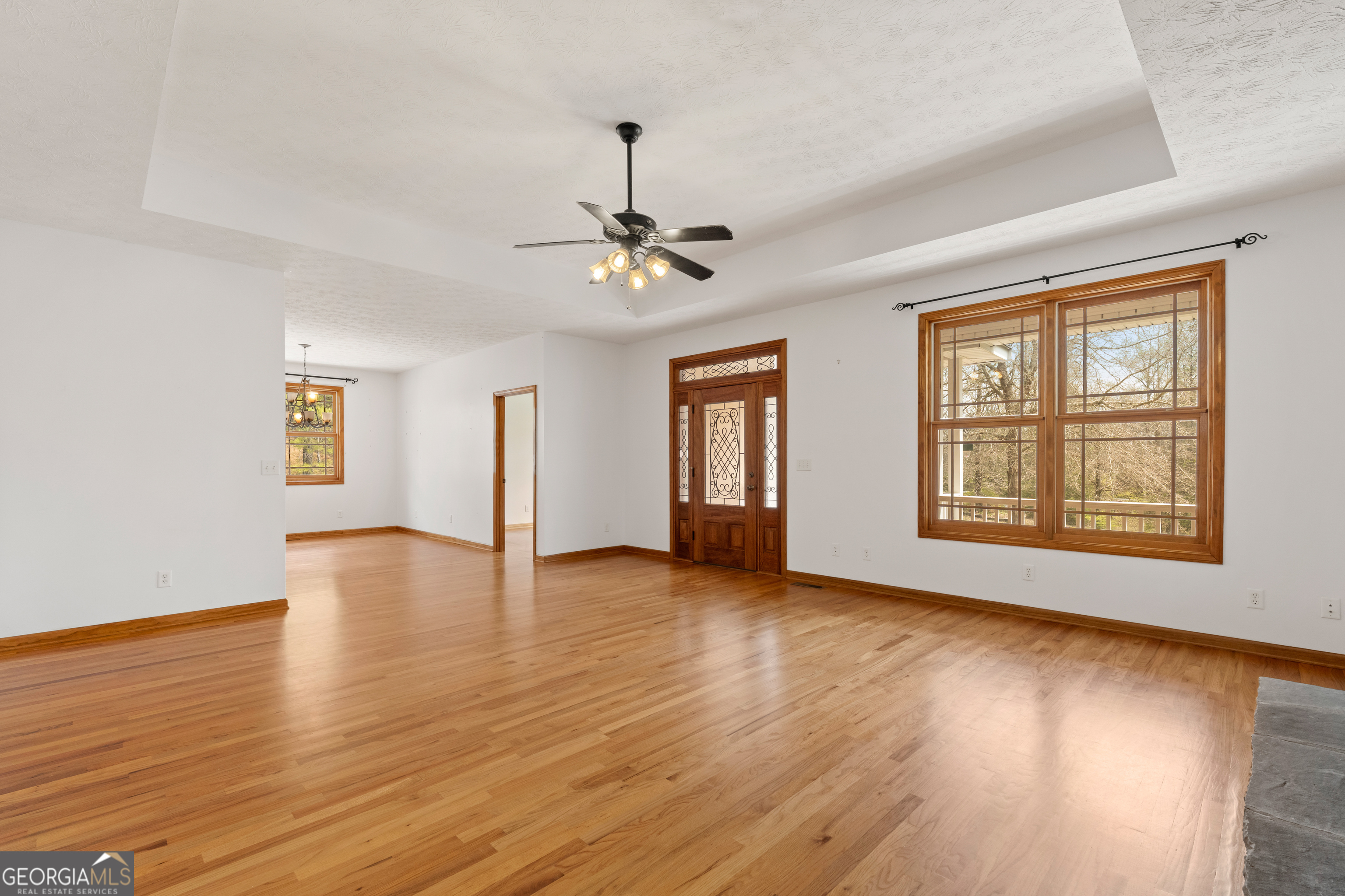 1229 Boggus Road Franklin, GA 30217 - Photo 11 of 68 a view of an empty room with window and wooden floor