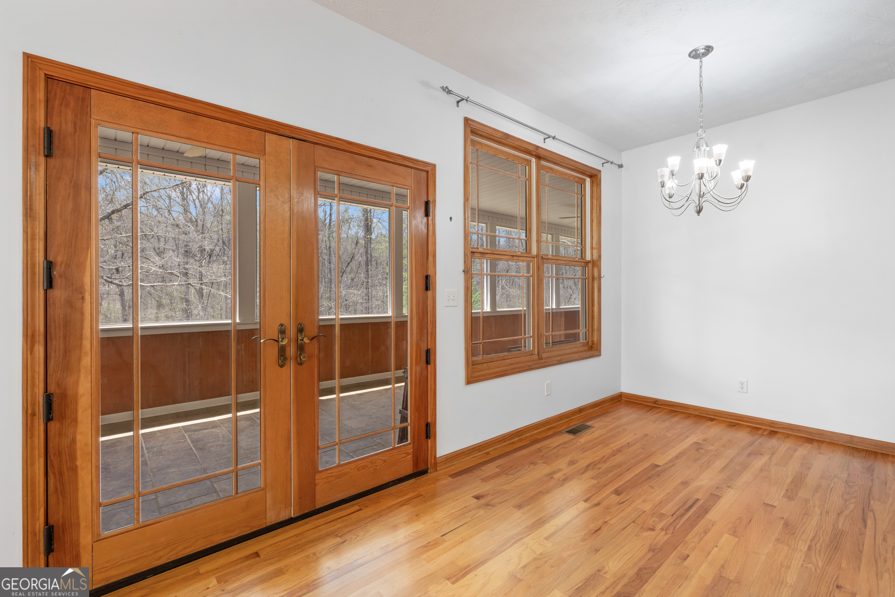 1229 Boggus Road Franklin, GA 30217 - Photo 15 of 68 a view of an empty room with wooden floor and a window