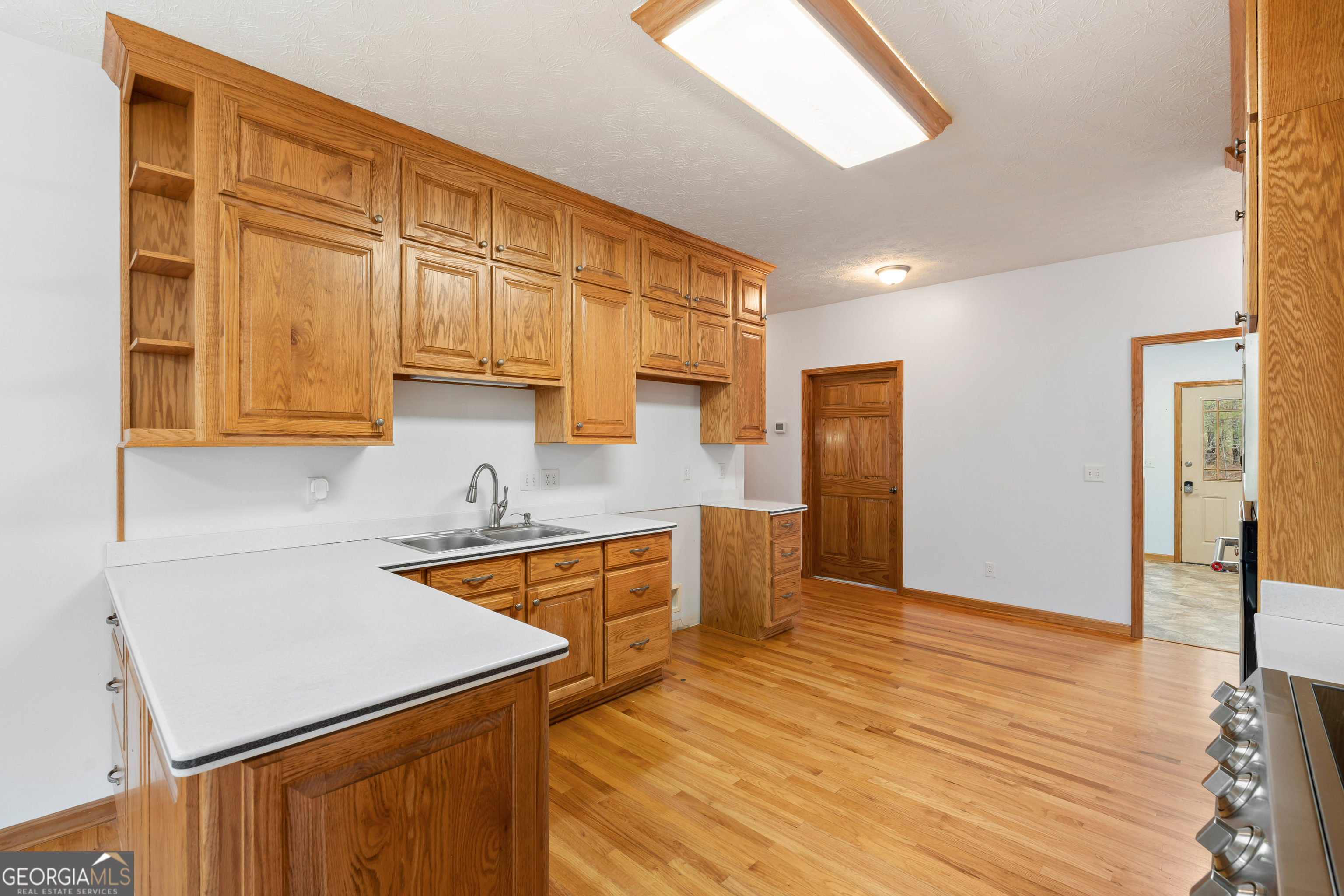 1229 Boggus Road Franklin, GA 30217 - Photo 17 of 68 a kitchen with stainless steel appliances granite countertop a sink and cabinets