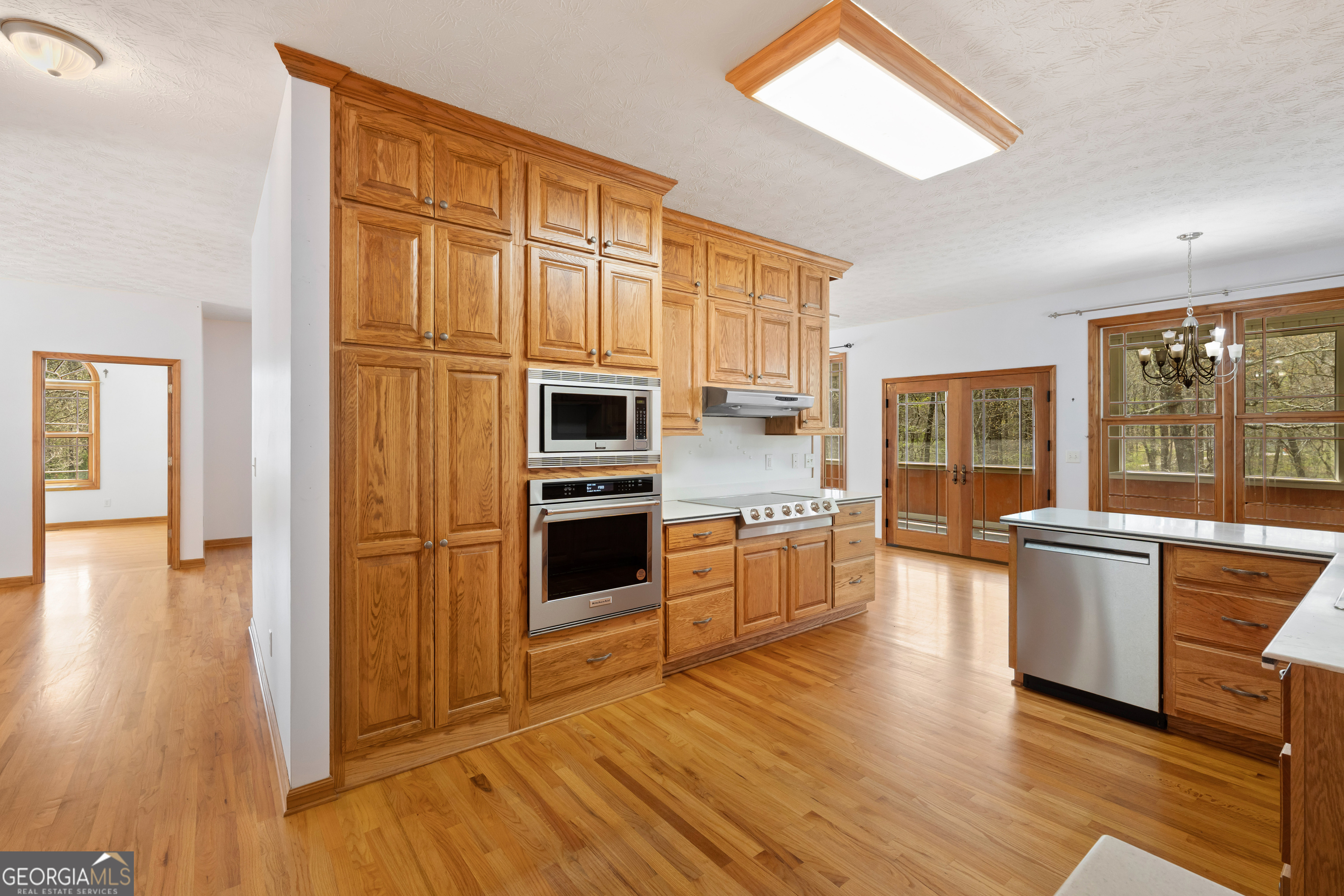 1229 Boggus Road Franklin, GA 30217 - Photo 20 of 68 a kitchen with stainless steel appliances a refrigerator a stove top oven and wooden floors